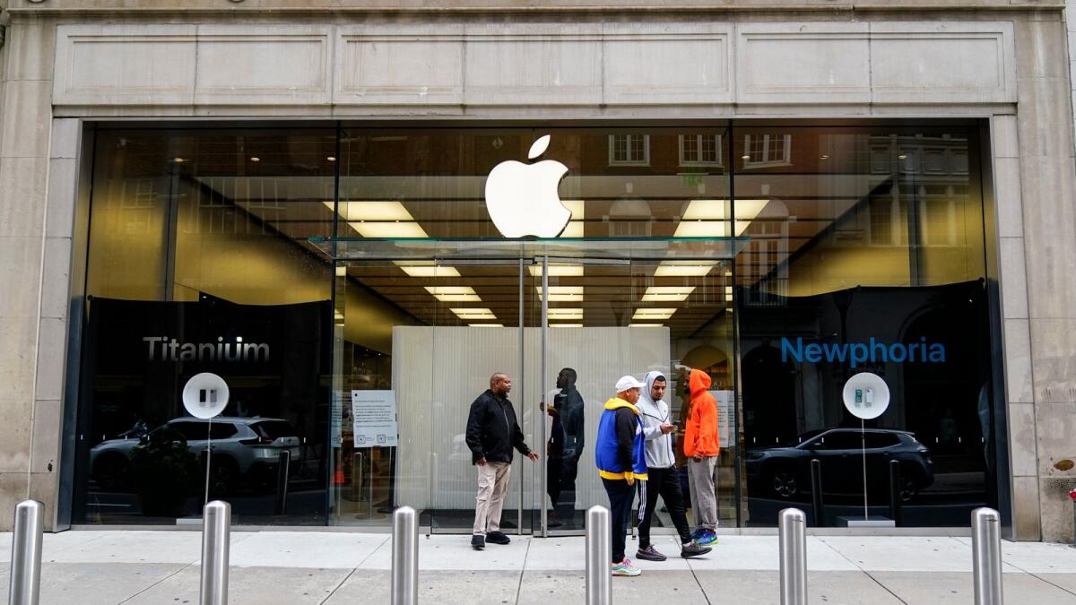 أشخاص يقفون خارج متجر Apple Store في فيلادلفيا بعد تعرضه للنهب.  — ا ف ب