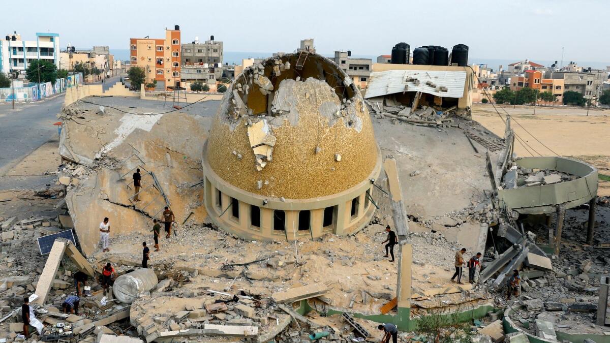 تصوير: فلسطينيون يتفقدون مسجدا مدمرا في خان يونس جنوب قطاع غزة (رويترز)