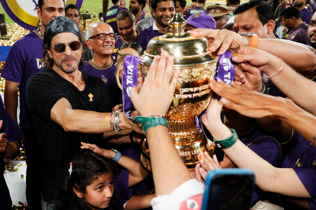 شاروخان، المالك المشارك لفريق Kolkata Knight Riders، يحتفل بالكأس.  — الشعيرات الضوئية المكثفة